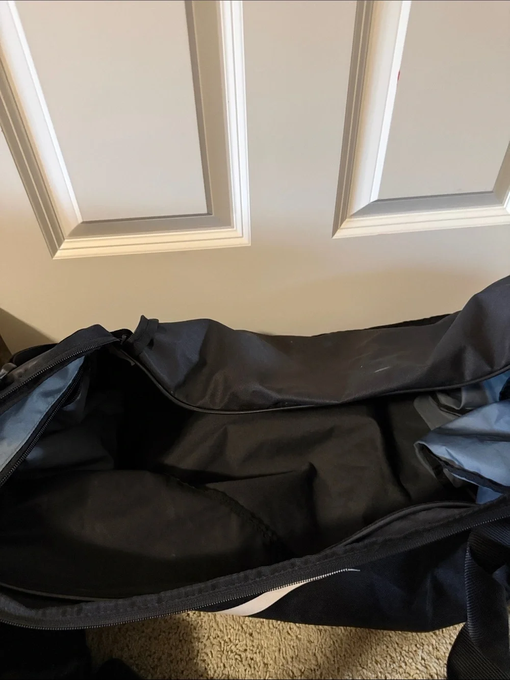 Nike Black Duffle Bag with White Swoosh and Adjustable Strap